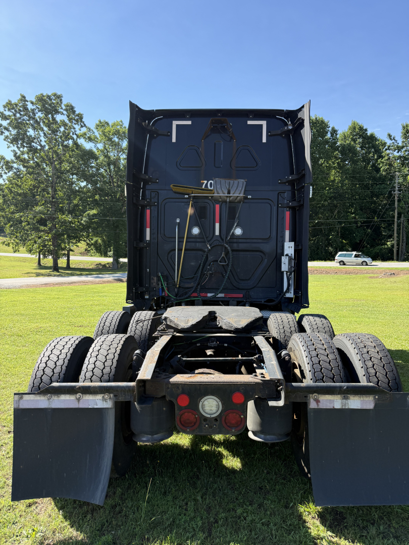 Truck rear view showing chassis, rear axles, and fifth-wheel mounting on a Freightliner Cascadia Evolution.