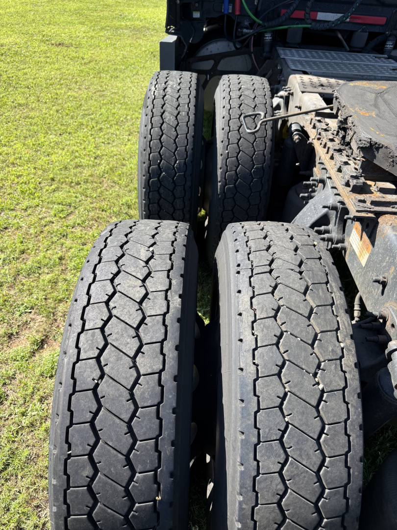 Dual rear tractor tires on a Freightliner Cascadia Evolution tractor showing tread pattern and wheel arrangement.
