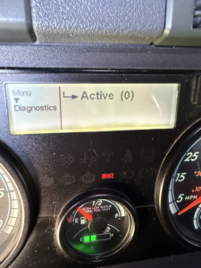 Dashboard touchscreen showing Active (0) status with diagnostics option and a fuel gauge in a Freightliner Cascadia Evolution truck.