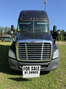 Front view of a Freightliner Cascadia Evolution truck with a license plate area that reads FOR SALE BY OWNER.