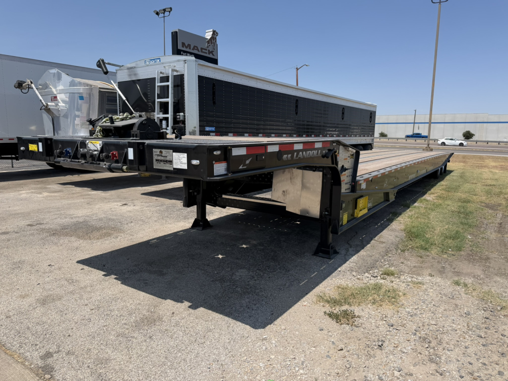 Landoll 440B-53 40-ton traveling axle lowboy trailer showing long deck, black toolbox, tandem frame, and support legs.