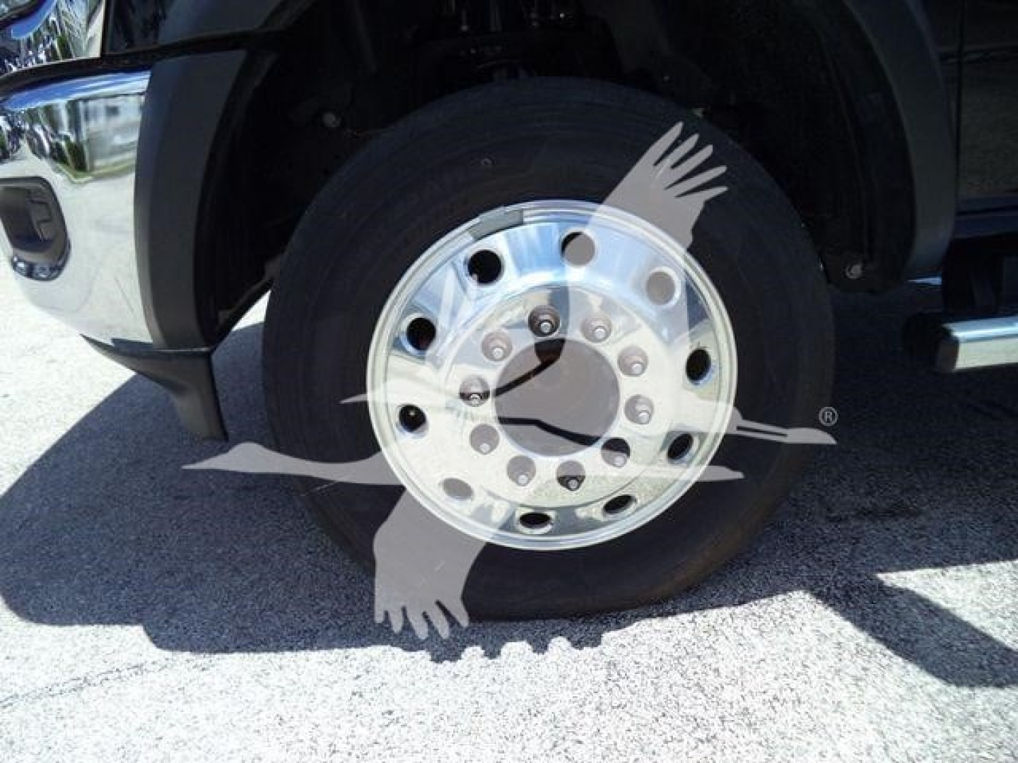 Truck front wheel showing polished aluminum rim and tire on the Ram 5500 SLT.