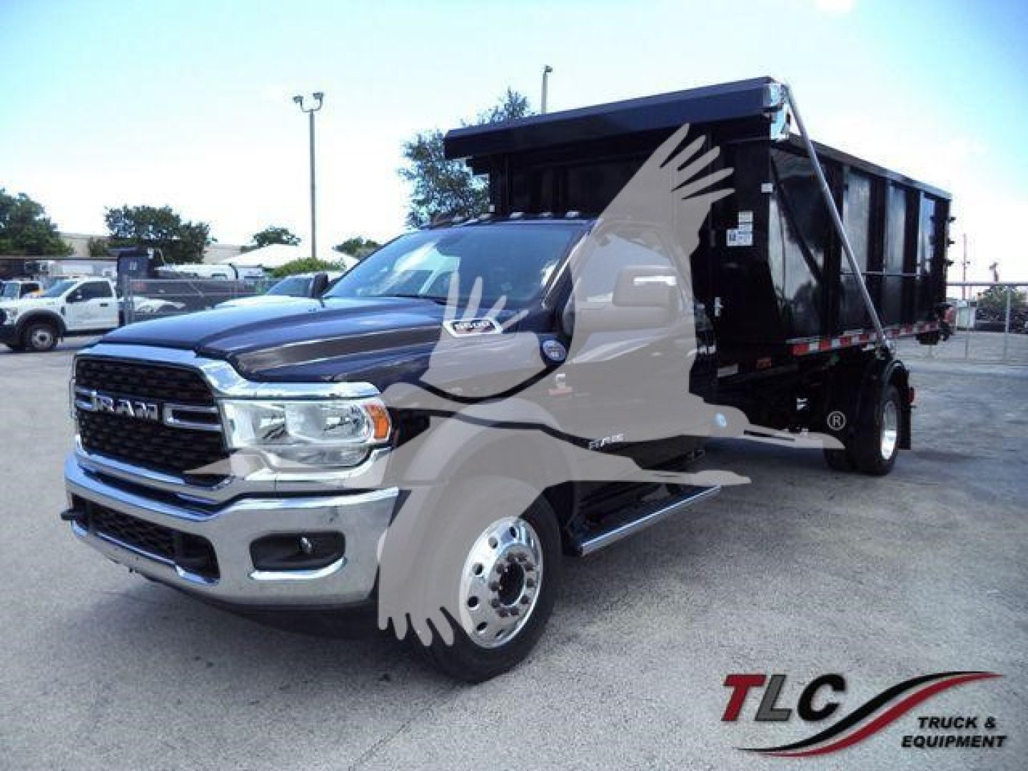 Ram 5500 SLT chassis cab with black dump bed/hooklift attachment, front grille, chrome bumper, dual rear wheels, logo watermarked in image.