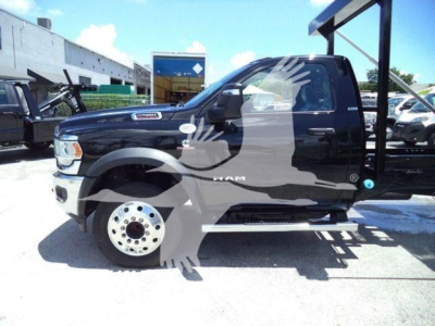 Ram 5500 truck side view showing cab and wheel, hooklift category visible with stock number label in background.