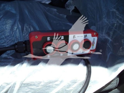 Ram 5500 Slt hooklift control panel with red housing and multiple circular ports, wiring harness attached.