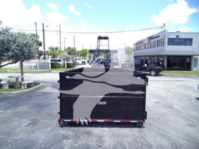 Ram 5500 SLT dump bed/truck rear view with hooklift storage and skyline.