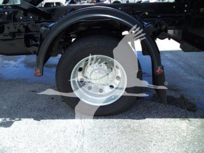 Ford Ram 5500 SLT truck wheel area showing front fender and single rear wheel with hubcap and suspension components.