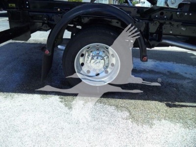 Wheel and suspension of a Ram 5500 chassis showing a polished hub and partial frame with a protective fender.