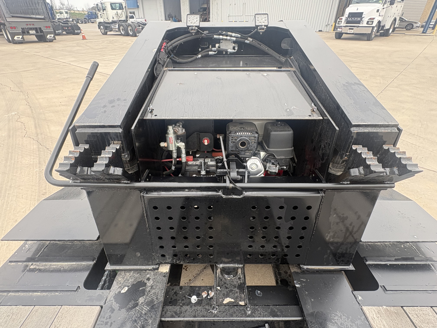 Load King 503/605-8'-6"-20" lowboy trailer rear view showing hydraulic system, engine, and perforated rear plate.