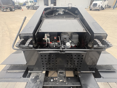 Load King 503/605-8'-6"-20" lowboy trailer rear view showing hydraulic system, engine, and perforated rear plate.