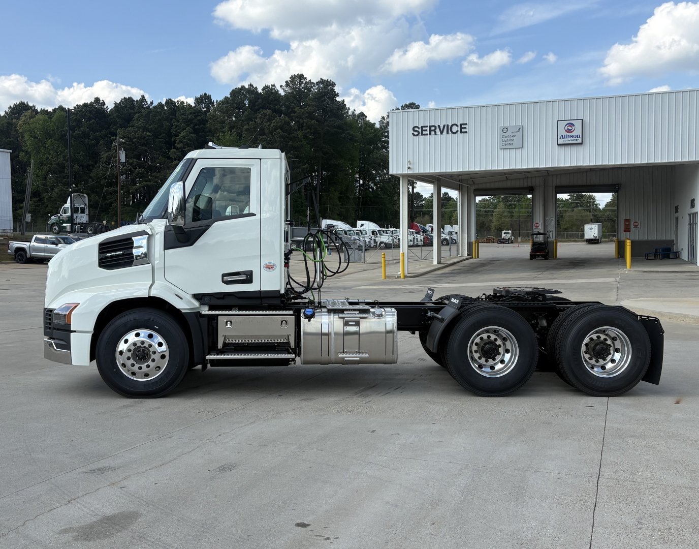 Mack AN64T daycab truck side view showing white cab and chassis with dual rear axles.