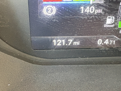 Image of a Mack AN64T truck dashboard showing 121.7 mi and 0.4 T1, 140 psi, diesel indicator, and fuel gauges.