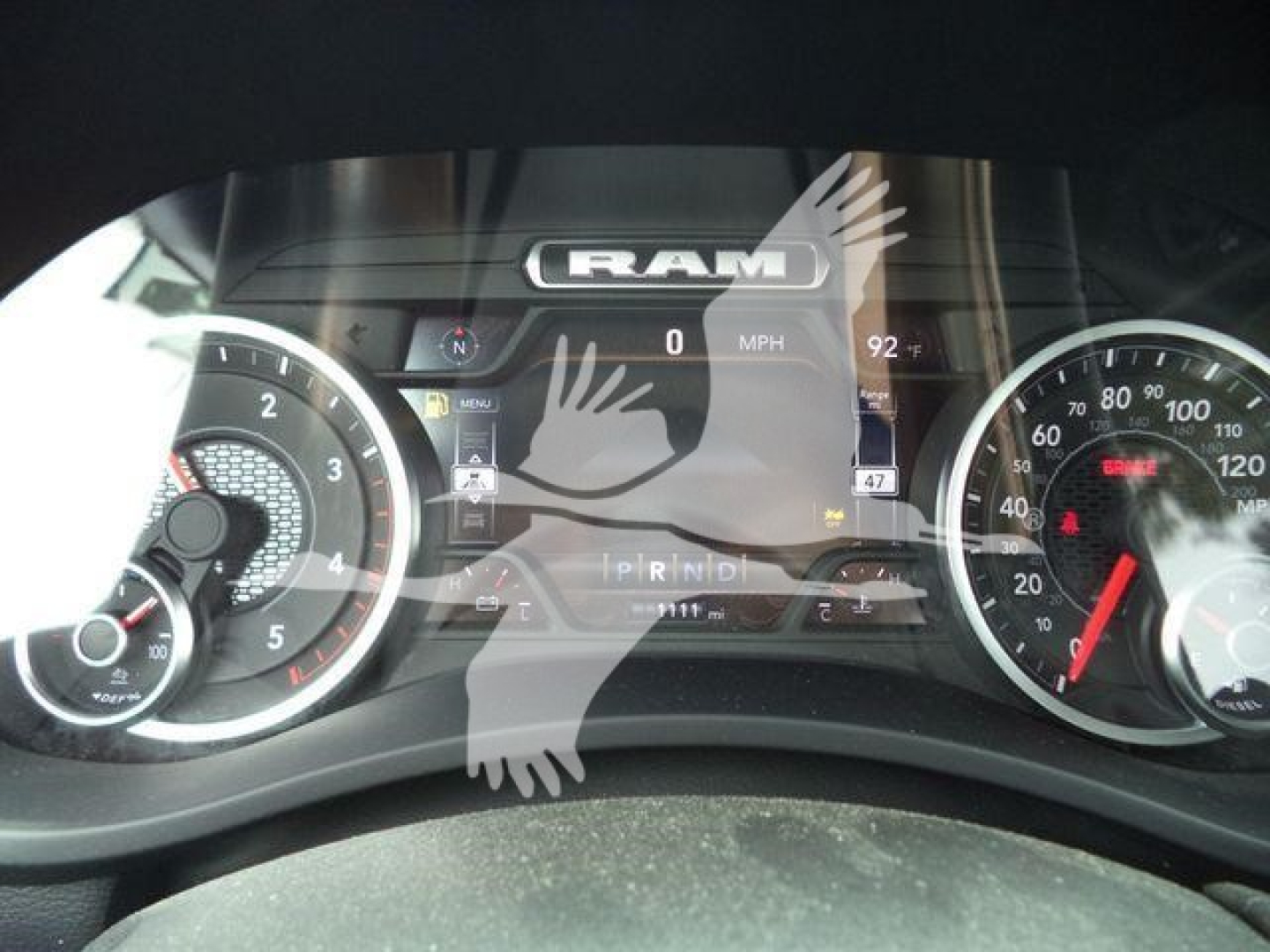 Dashboard of a 2026 Ram 5500 Big Horn showing RAM logo on digital display; gauge clusters on left and right with speedometer and tachometer; PRND gear indicator visible.