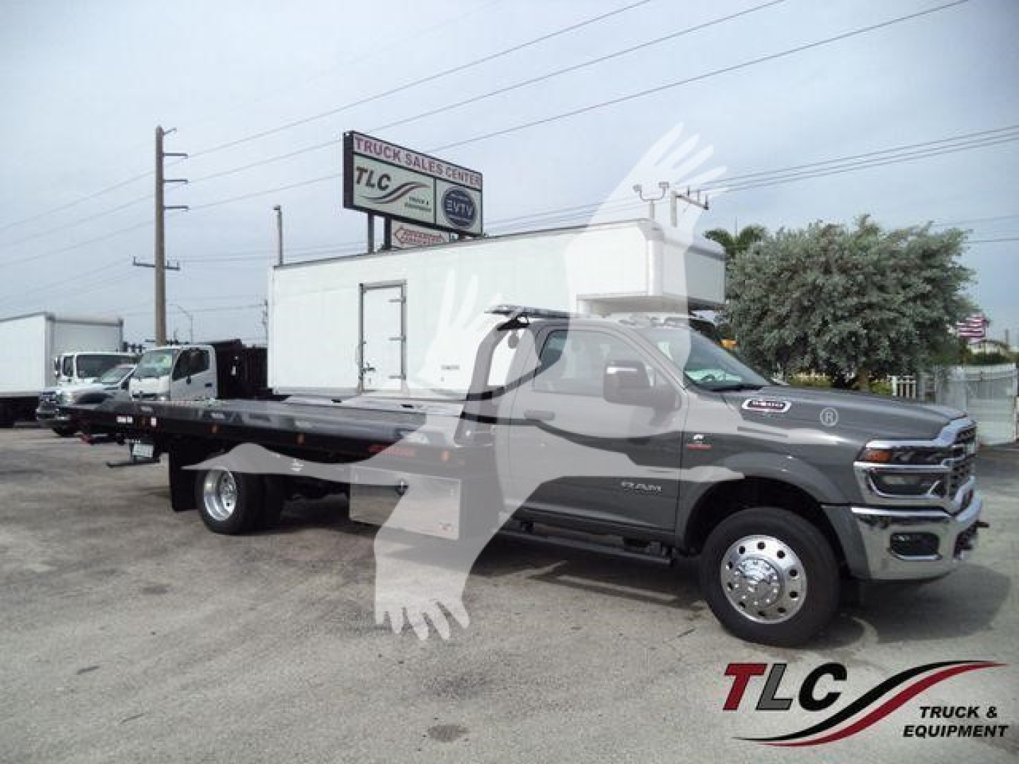Ram 5500 rollback truck side view with flatbed and dual rear wheels, 2026 Big Horn, gray exterior, TLC Truck & Equipment watermark