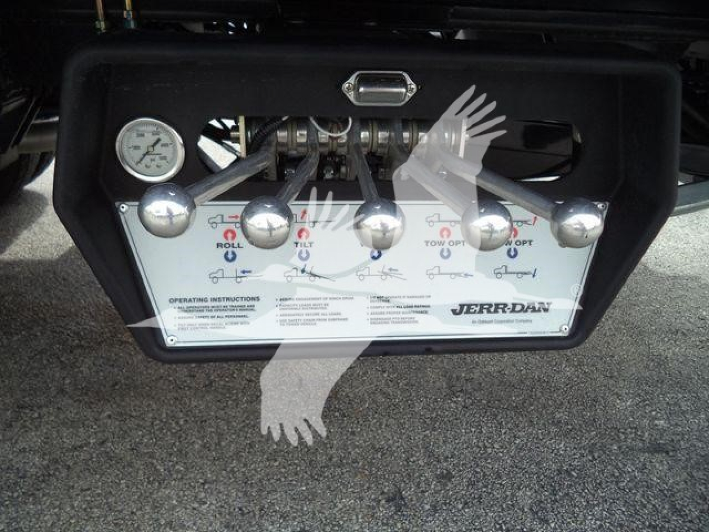 Ram 5500 rollback control panel with multiple levers labeled with directions and a pressure gauge on the left; brand JerBen? visible on the panel.