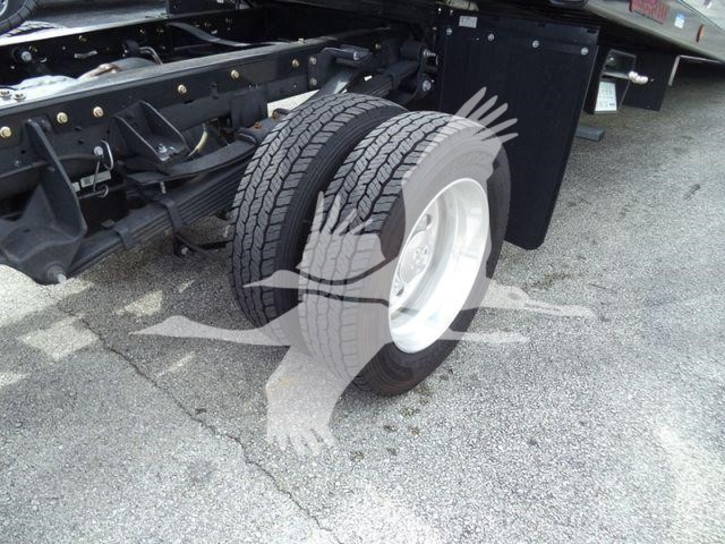 Ram 5500 rollback truck rear wheel and chassis view showing dual rear tires and suspension components.