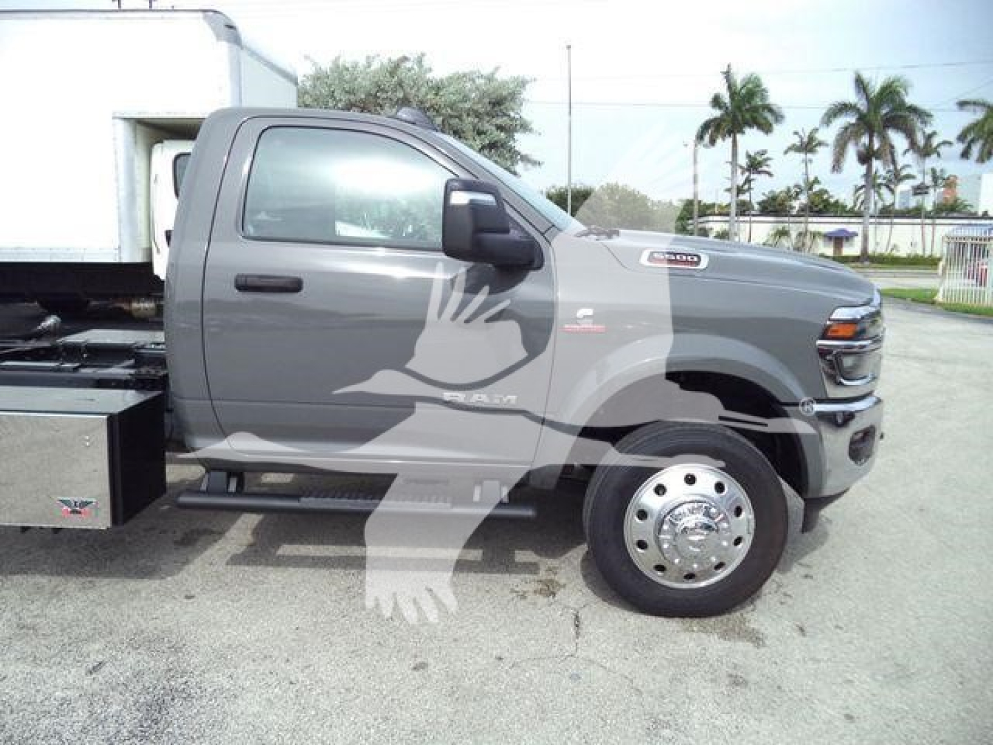 Ram 5500 rollback truck side view showing cab and front wheel with aluminum dual rear wheels and utility toolbox