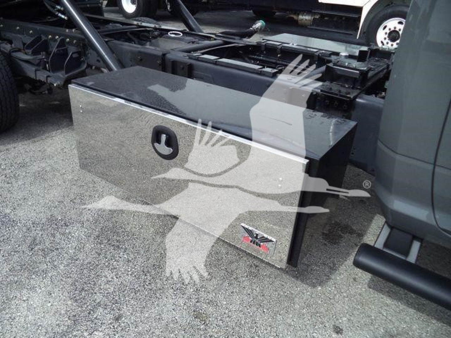 Ram 5500 rollback truck toolbox with JPRO logo and side emblem, mounted under truck bed, showing polished metal rectangular toolbox.