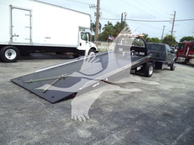 Ram 5500 rollback bed in open lot with ramp extended.
