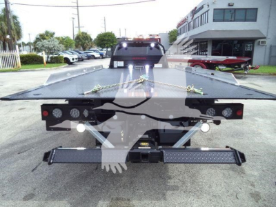 Ram 5500 rollback truck bed with tow hooks and rear lights, displaying a flatbed platform and winch area.