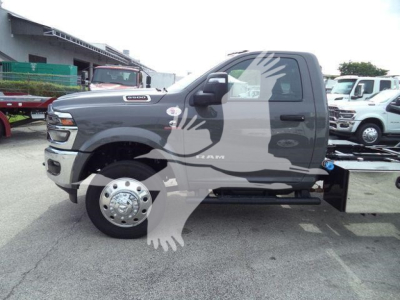 Ram 5500 Big Horn utility truck side view showing body, dual rear wheels, and large fuel tank with chrome hubcaps.