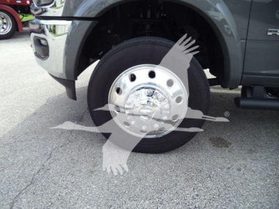 Truck wheel with hubcap and front fender of a Ram 5500 Big Horn, showing tire, rim, and part of the wheel well.