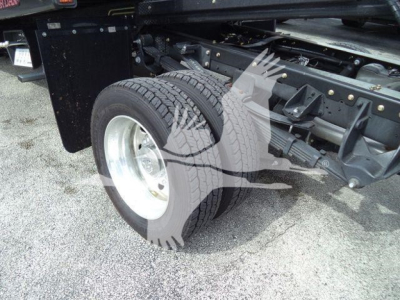 Ram 5500 rollback truck rear wheel and chassis showing suspension and dual rear wheels.