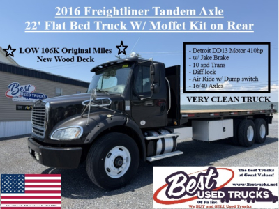 Flatbed Freightliner M2-112 tandem axel truck with 22' bed and rear Moffet kit, text overlays show features and very clean truck.