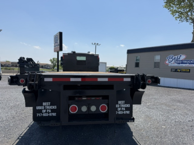 Freightliner M2-112 flatbed truck rear view showing taillights and mudflaps with Best Used Trucks of PA branding.
