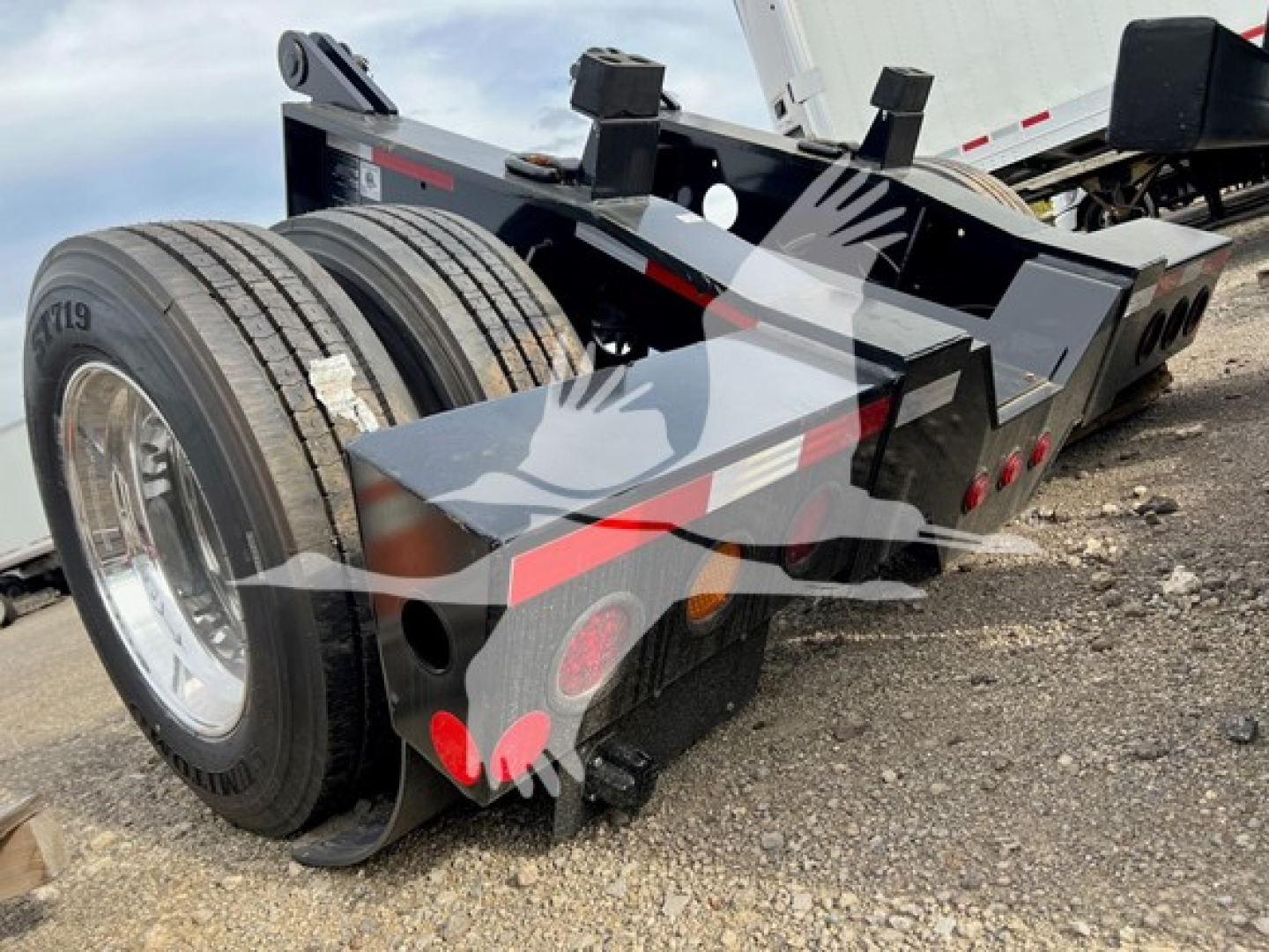 Fontaine rear flip trailer shown in a lowboy configuration with dual rear axles and hydraulic components.