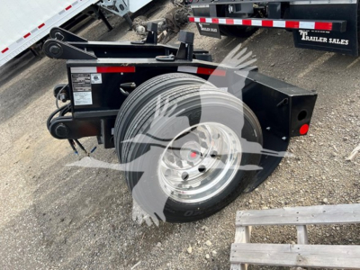 Fontaine rear flip trailer component showing a spare wheel on a black frame with hydraulic components and safety decals.