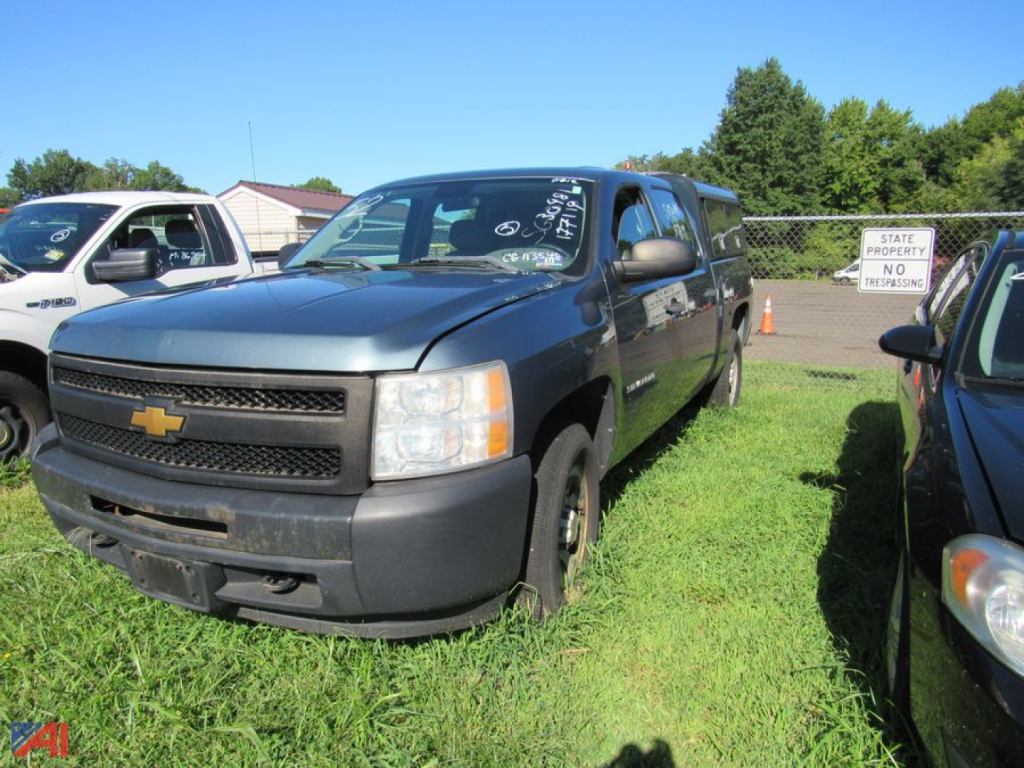 20012 Chevrolet Silverado 1500 pickup truck in a lot, front left view, dark blue/gray with black bumper and Chevrolet emblem visible.