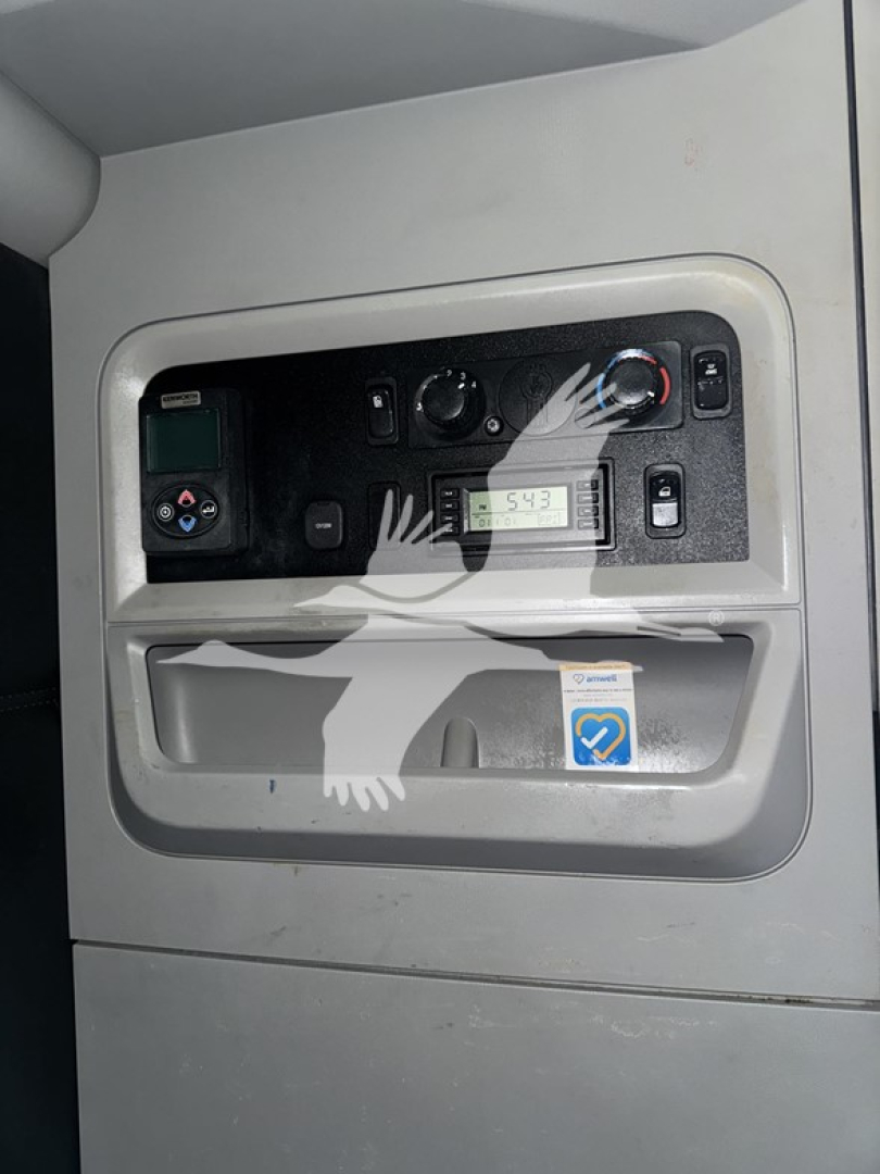Truck cab interior panel with gauges and controls visible in the door pocket area.