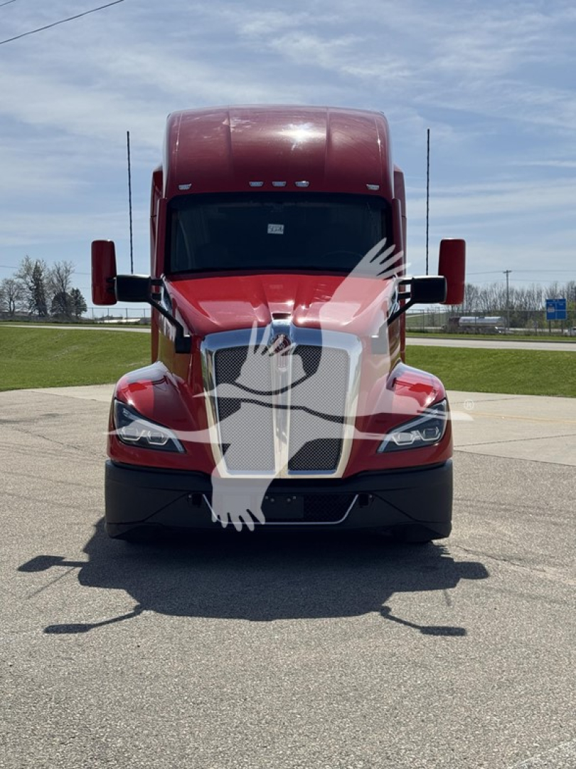 Front view of a red 2022 Kenworth T680 truck showing the grille, headlights, and side mirrors. Wind deflector and hood visible with no legible serials or labels.