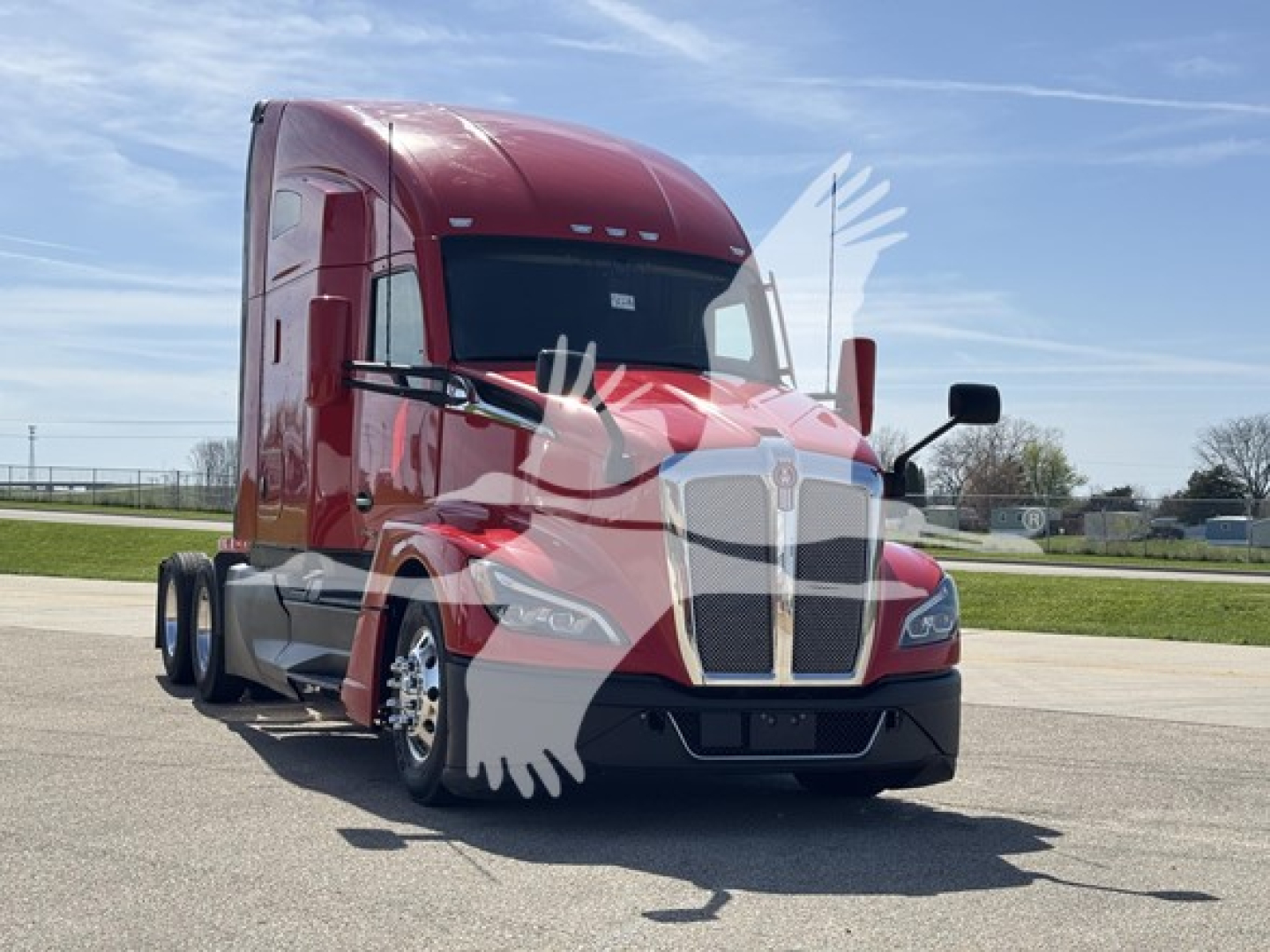 Kenworth T680 sleeper cab truck in red, front three-quarter view, showcasing grille and headlights.