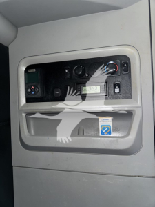 Truck cab interior panel with gauges and controls visible in the door pocket area.