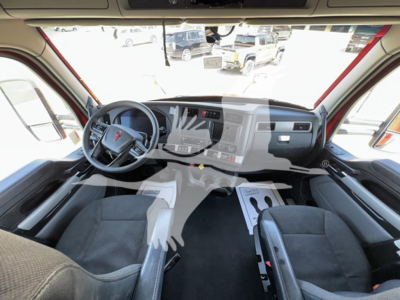 Kenworth T680 cab interior from driver seat perspective showing steering wheel and dashboard with center console.