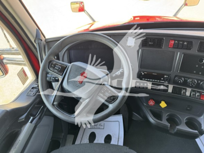 Kenworth T680 truck interior dashboard and steering wheel view with gray steering wheel, digital display, and controls.