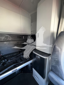 Truck cab interior with sleeper area and storage cabinet; no legible model text visible in this image.