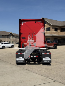 Kenworth T680 rear view showing red cargo area, black bumper and mudflaps with Koal Truck & Trailer logos.