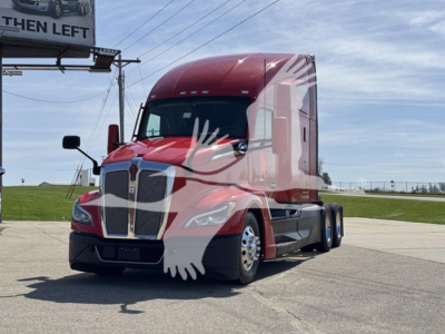 Kenworth T680 sleeper cab tractor in red, front-left view, with VIN/stock details text blurred in background.