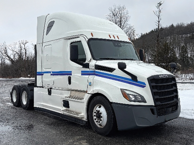 Freightliner Cascadia126 tractor-trailer cab in white with blue stripe, side view showing front grille and sleeper cabin.