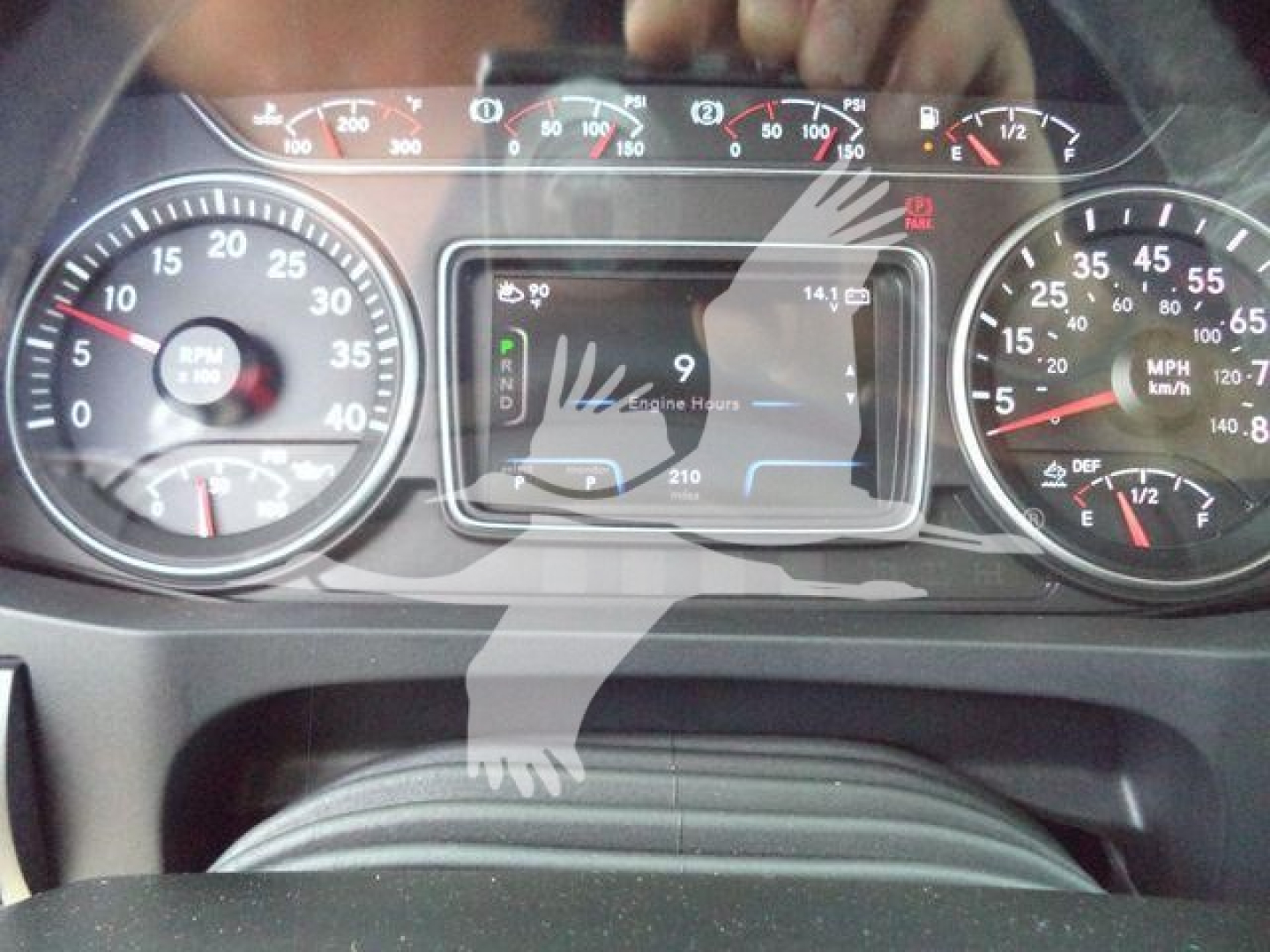 Dashboard view of a truck showing gauges, digital display, and speedometer. Instrument cluster with rpm gauge and mph gauge visible.
