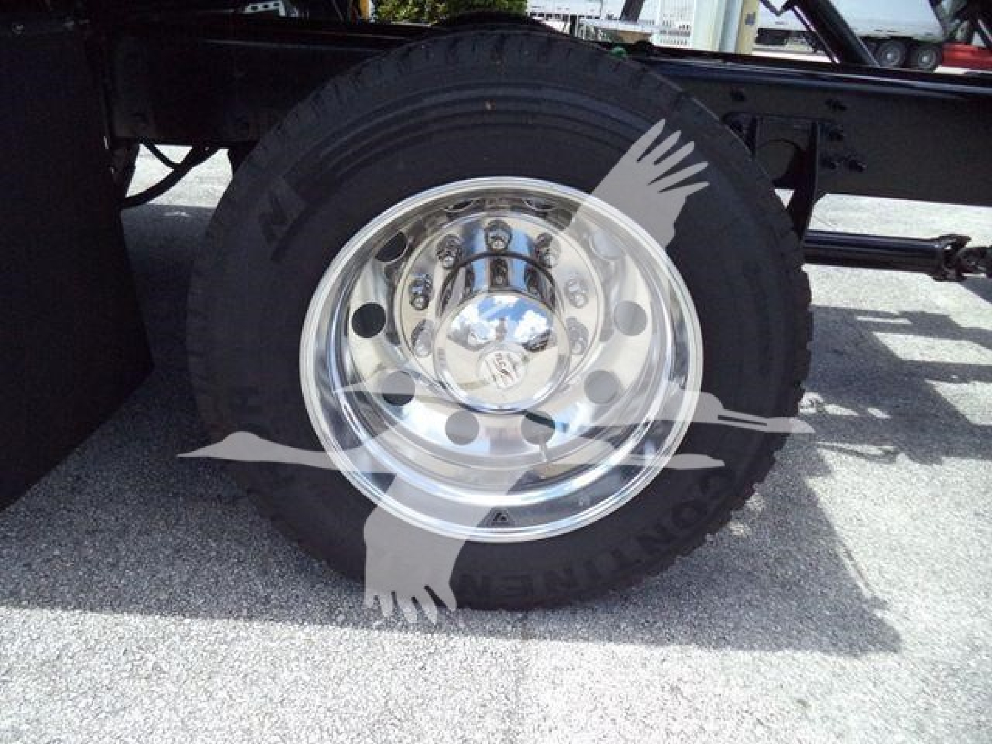 Truck wheel and tire on a rollback truck with a chrome hub and black tire