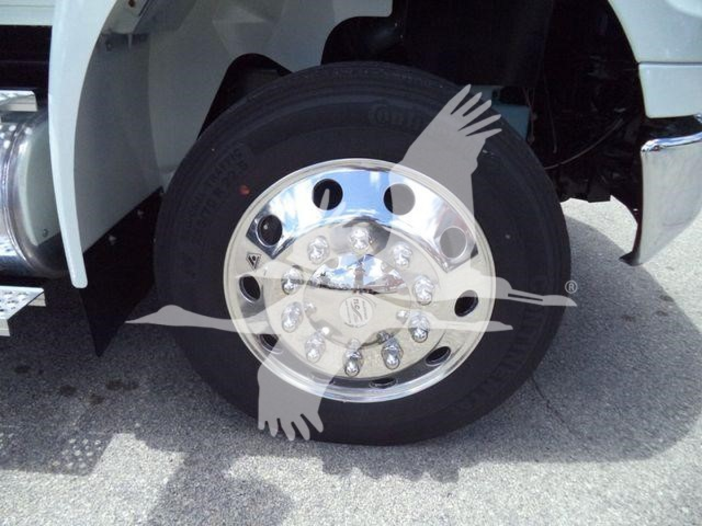 INTERNATIONAL truck wheel with polished chrome hub and tire; no visible text other than wheel and fender details.