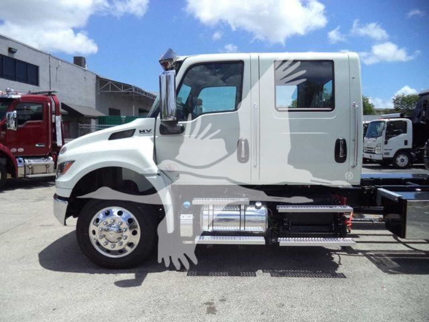 International MVX truck cab side view showing chrome fuel tanks and steps with windowed cab