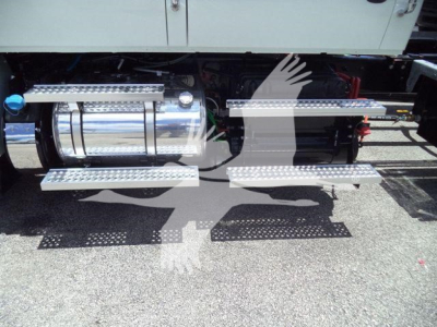 Truck undercarriage showing chrome fuel tank and side steps on International MV rollback truck.