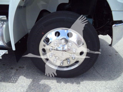 INTERNATIONAL truck wheel with polished chrome hub and tire; no visible text other than wheel and fender details.