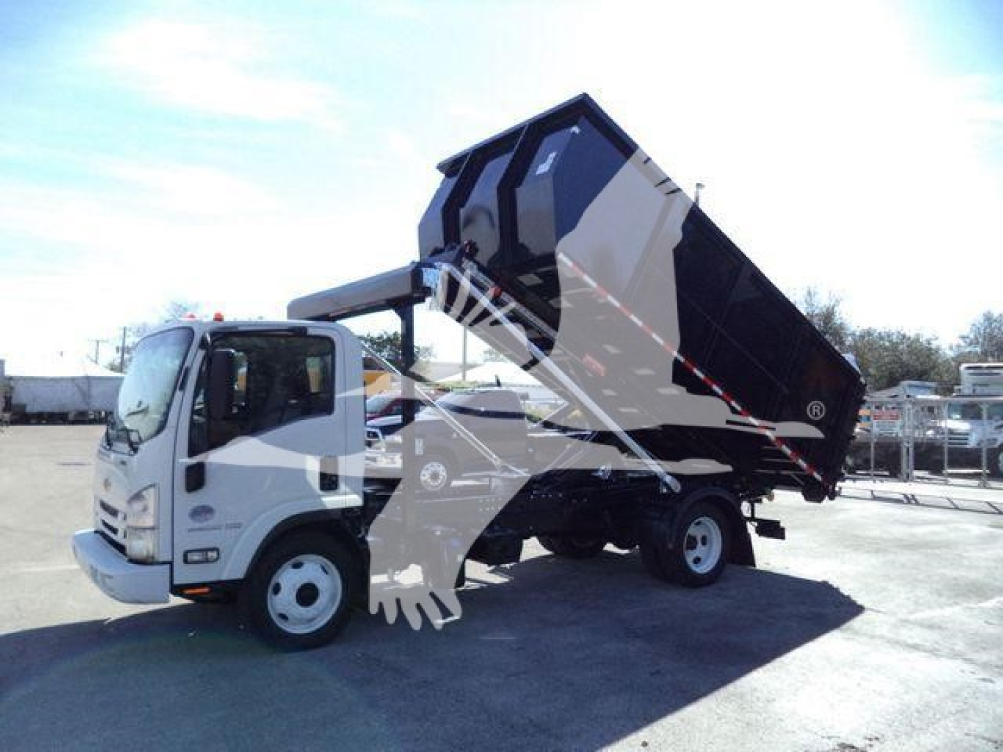Isuzu NPR/NRR dump truck with raised dump bed, front cab and tilt mechanism visible