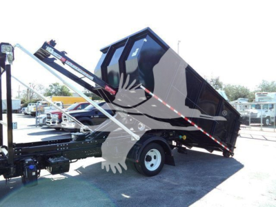 Isuzu NPRR truck with rolloff bed in raised position showing hydraulic system and container bed